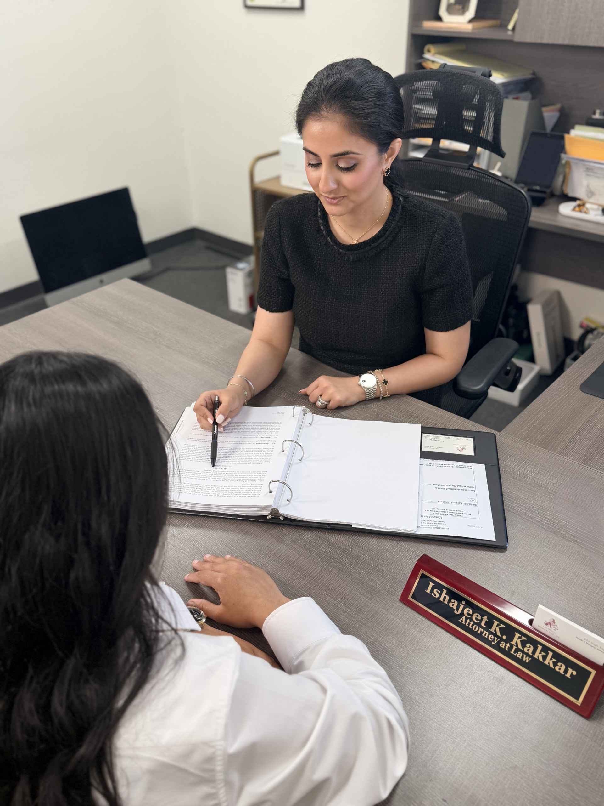 Ishajeet K. Kakkar Attorney at Law consulting with client at law office desk